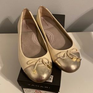 Like new Tahari flats in vanilla and gold. Cute tassel on top